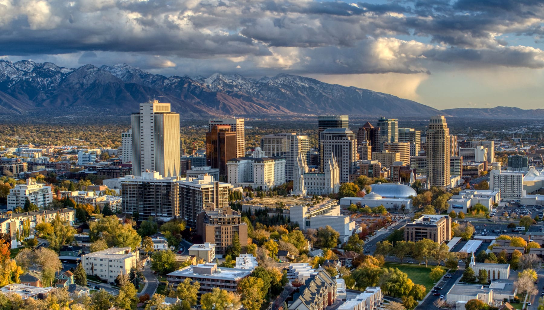 Photo of downtown Salt Lake City and the Wasatch mountains with a cloudy sky