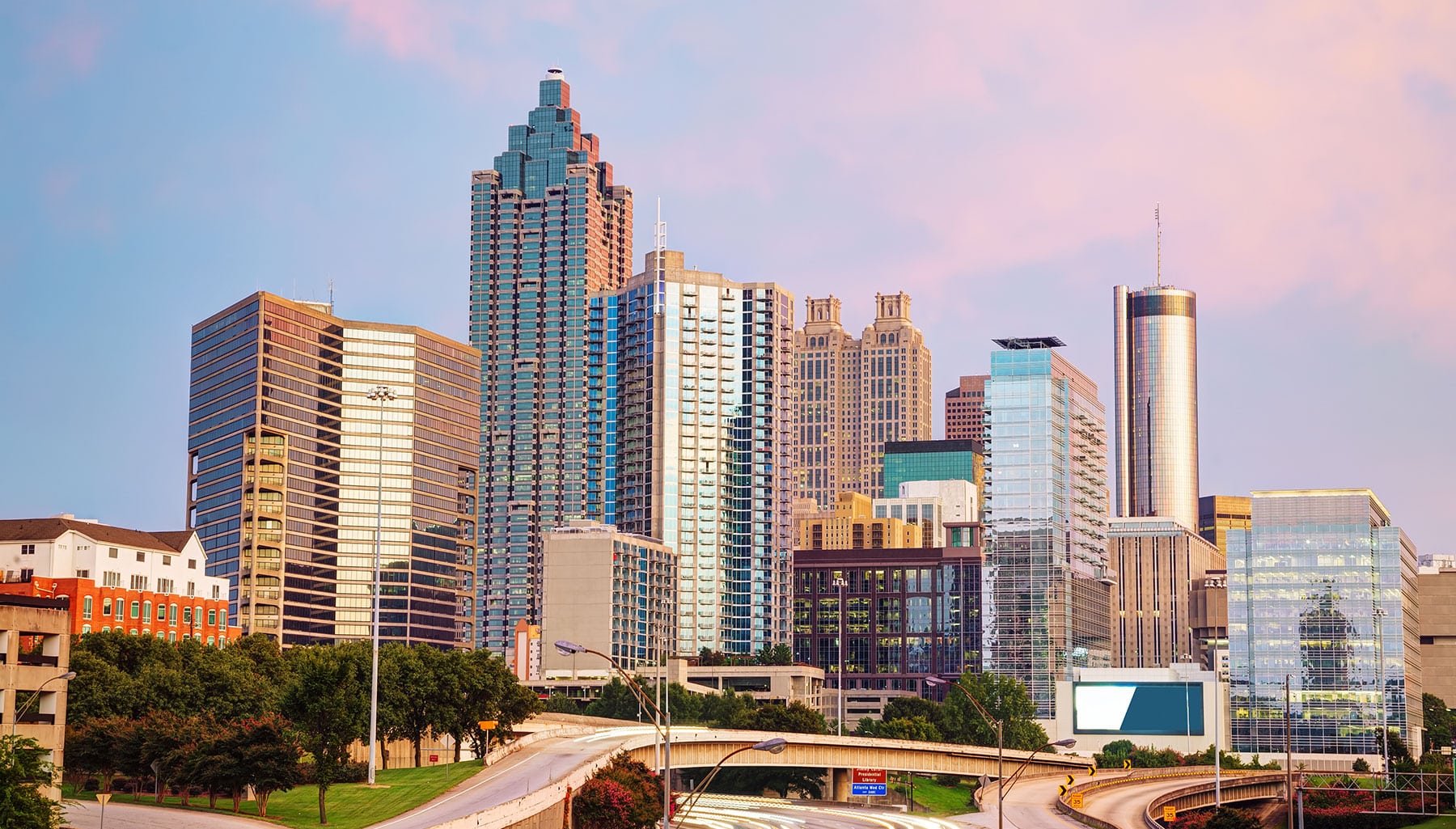 Downtown Atlanta, GA, with pink sky and freeway in front